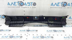 The trunk opening trim for a Toyota Rav4 19-24 is black, with scratches and whitened plastic.