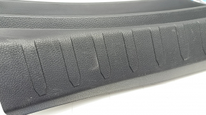 The trunk opening trim for a Toyota Rav4 19-24 is black, with scratches and whitened plastic.