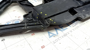 The lower deflector of the front bumper of the Toyota Camry v70 18-24 USA plastic is cracked.