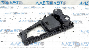 The center console trim with cup holders for the Audi A5 F5 17-19 is black, ebony-like, and the coating is swollen.