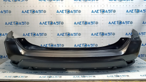 Bare rear bumper of a 17-20 Nissan Rogue without parking sensors, scratches