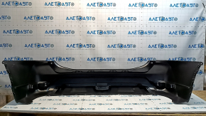 Bare rear bumper of a 17-20 Nissan Rogue without parking sensors, scratches