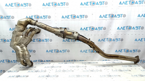 The exhaust manifold with a catalytic converter for a Subaru Forester 19-24 SK is dented.