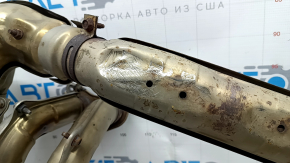 The exhaust manifold with a catalytic converter for a Subaru Forester 19-24 SK is dented.