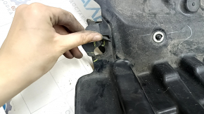 The front left fender liner of a Subaru Forester 19-21 SK is torn.