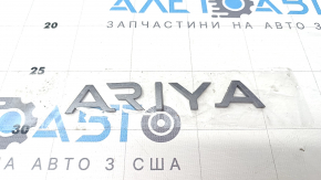 The "ARIYA" emblem on the tailgate of the Nissan Ariya 23-25