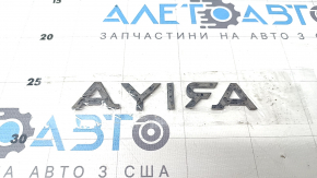 The "ARIYA" emblem on the tailgate of the Nissan Ariya 23-25