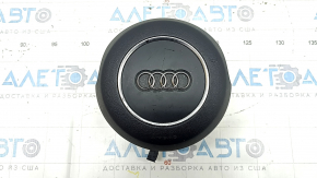 The steering wheel airbag for the driver's side of the Audi A6 C7 12-18 is black and scratched.