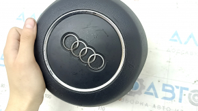 The steering wheel airbag for the driver's side of the Audi A6 C7 12-18 is black and scratched.