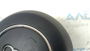 The steering wheel airbag for the driver's side of the Audi A6 C7 12-18 is black and scratched.