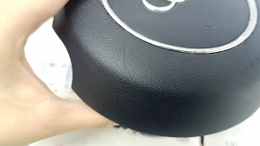 The steering wheel airbag for the driver's side of the Audi A6 C7 12-18 is black and scratched.