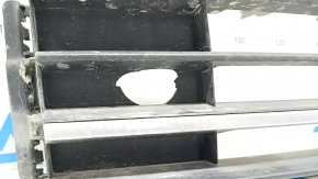 The central grille of the front bumper of the VW Passat b8 16-19 USA is missing an element, sand