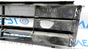 The central grille of the front bumper of the VW Passat b8 16-19 USA is missing an element, sand