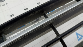 The central grille of the front bumper of the VW Passat b8 16-19 USA is missing an element, sand