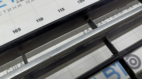 The central grille of the front bumper of the VW Passat b8 16-19 USA is missing an element, sand