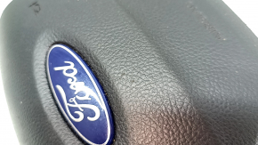 Black, scratched steering wheel airbag for the driver's side of a Ford Ecosport 18-22.