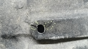 The right underbody protection of the Audi A6 C7 12-18 is worn and torn.