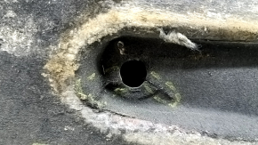 The right underbody protection of the Audi A6 C7 12-18 is worn and torn.