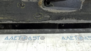 The right underbody protection of the Audi A6 C7 12-18 is worn and torn.