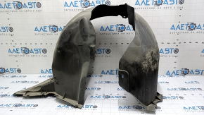 The front right fender liner of a VW Passat b8 16-19 USA is torn.