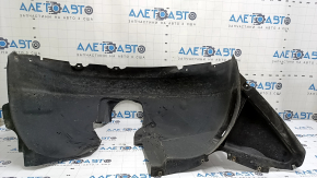 The front right fender liner of a VW Passat b8 16-19 USA is torn.