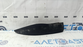 The left front bumper mudguard of an Audi A4 B9 17-25 is worn and scratched.