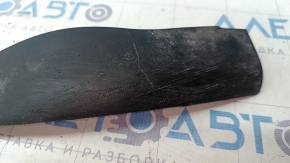 The left front bumper mudguard of an Audi A4 B9 17-25 is worn and scratched.