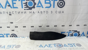 The right front bumper mudguard of an Audi A4 B9 17-25 is worn and scratched.
