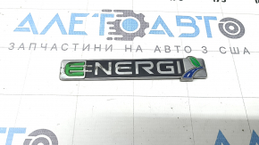 The ENERGI emblem on the front left door of a Ford Fusion mk5 13-20 is worn out.
