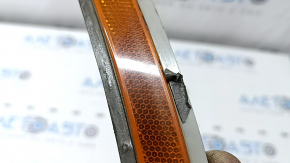 The front bumper reflector, left, BMW 5 G30 17-23, is worn.