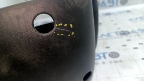 The steering column frame assembly for a Jeep Compass 17-18 is black, cracked, and the mounting is broken.