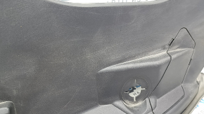 The right underhood trunk trim of the 2021-23 Ford Mustang Mach-E is worn.