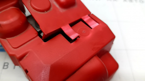 The positive terminal of a Ford Mustang Mach-E 21-23 has a broken cover and scratches.