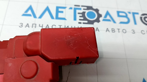 The positive terminal of a Ford Mustang Mach-E 21-23 has a broken cover and scratches.