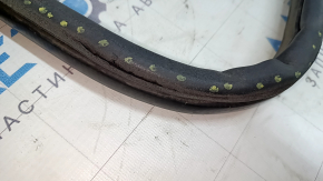 The front right door seal of the Kia Optima 11-16 is worn and torn.