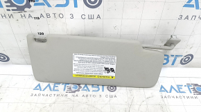 Left sun visor for a VW Jetta 19-24, gray, no hook, no light, dents, needs cleaning