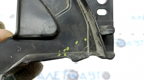 The left radiator grill bracket for Mazda CX-30 20-23 is dented and cracked.