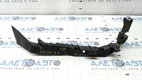 The front right headlight bracket for a Mazda CX-30 20-23 is broken.