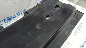Front left underbody protection for Mazda CX-30 20-23 is worn and dented.