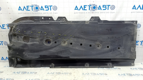The front right underbody protection of the Mazda CX-30 20-23 is worn and cracked.