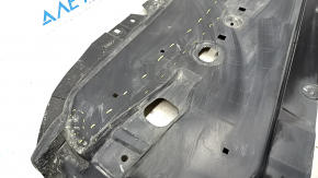 The front right underbody protection of the Mazda CX-30 20-23 is worn and cracked.