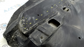 The front right underbody protection of the Mazda CX-30 20-23 is worn and cracked.