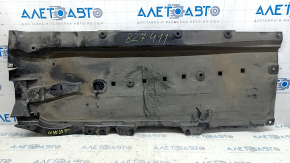 The front right underbody protection of the Mazda CX-30 20-23 is worn and cracked.