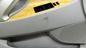 The front left door panel of a Toyota Camry v40 is gray, the armrest is gray leather, the insert is wood, with a handle, no controls, the plastic has turned white, needs cleaning, the leather has peel