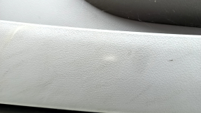 The front left door panel of a Toyota Camry v40 is gray, the armrest is gray leather, the insert is wood, with a handle, no controls, the plastic has turned white, needs cleaning, the leather has peel