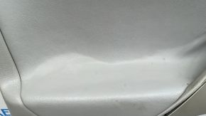 The front left door panel of a Toyota Camry v40 is gray, the armrest is gray leather, the insert is wood, with a handle, no controls, the plastic has turned white, needs cleaning, the leather has peel