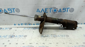 The rear left shock absorber of a Toyota Camry v40 XLE is rusty.
