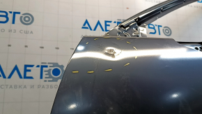 The front left door of a Mazda CX-9, 16-23, has a dent and a bump.
