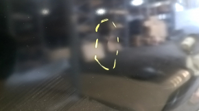 The front left door of a Mazda CX-9, 16-23, has a dent and a bump.