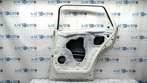 The bare rear right door of a Mazda CX-9 16-23 white 25D, bumps, dent